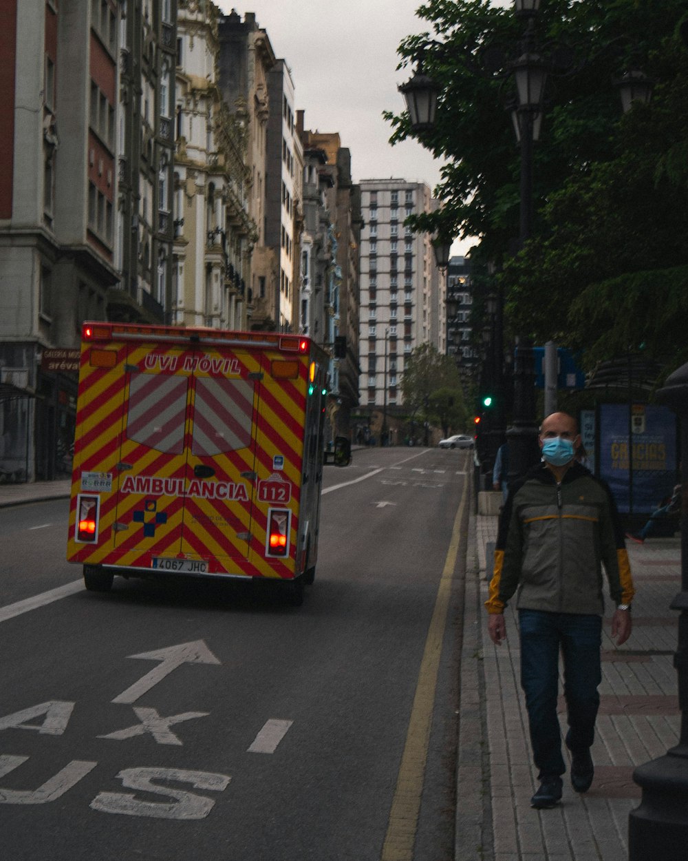 man in black jacket standing on pedestrian lane during daytime