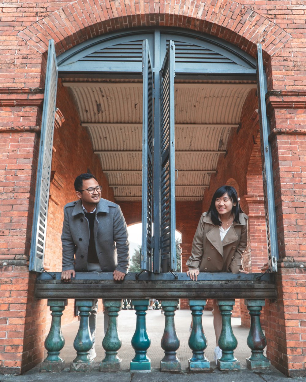 Mann und Frau stehen auf braunen Holztreppen