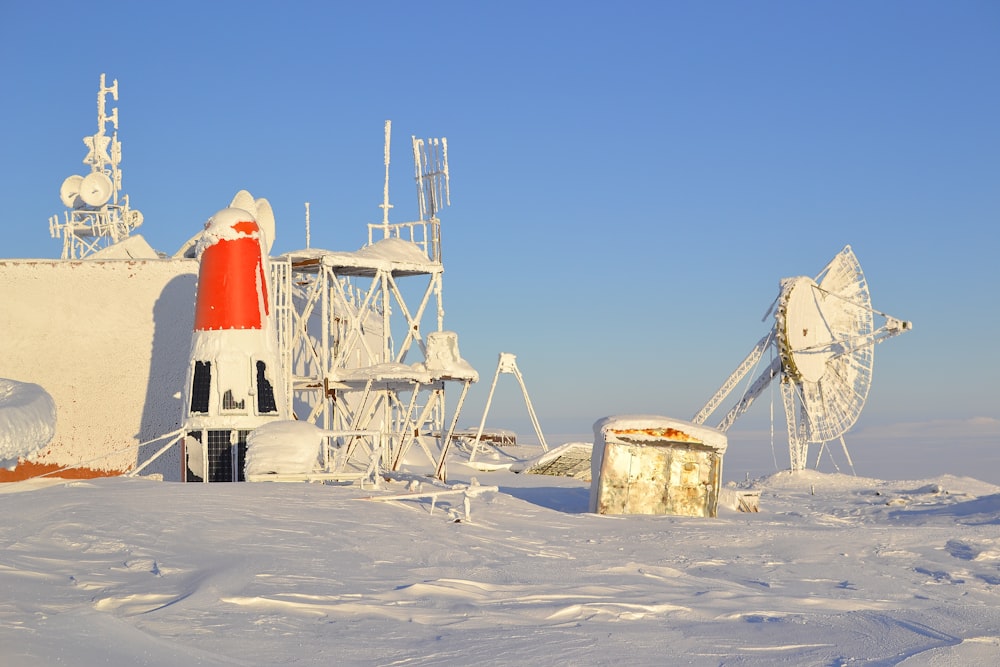 white and red lighthouse on white sand during daytime