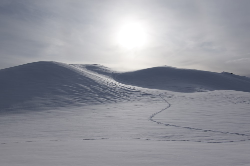 white sand under white clouds during daytime