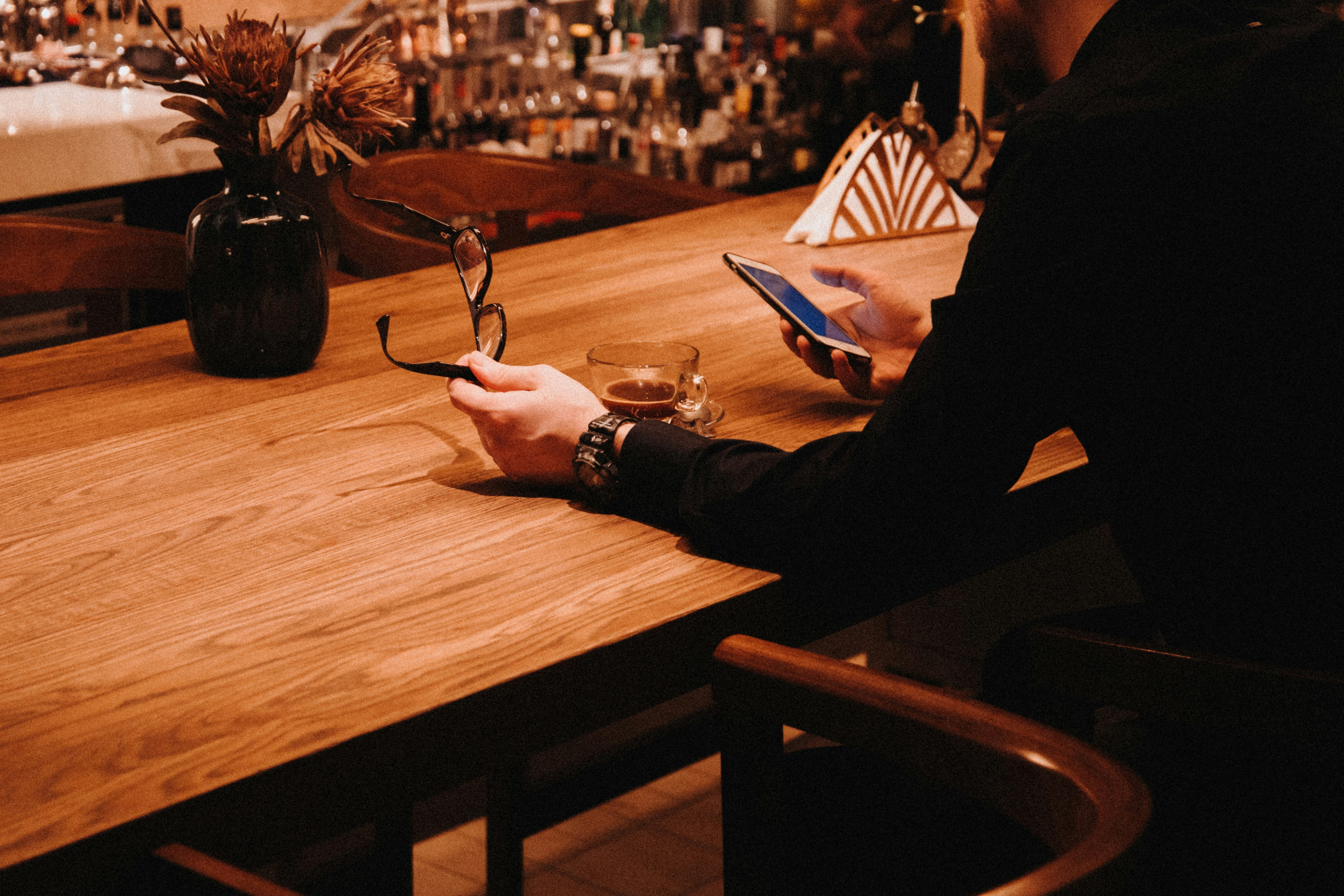 black framed eyeglasses on brown wooden table