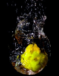 yellow fruit in water with water droplets