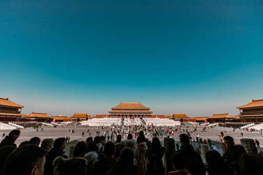 people standing near brown building during sunset in The Palace Museum China
