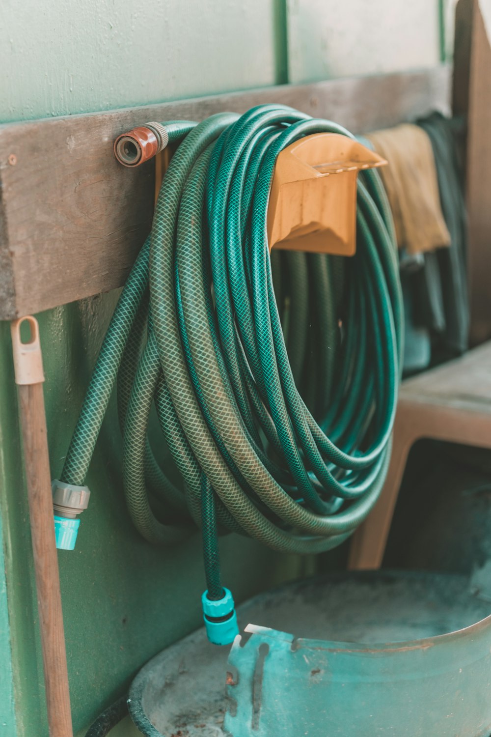 green and yellow hose on brown wooden table