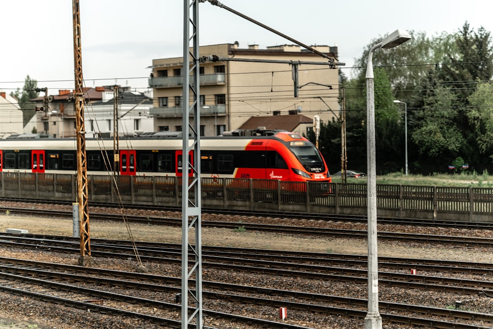 red and white train on rail tracks