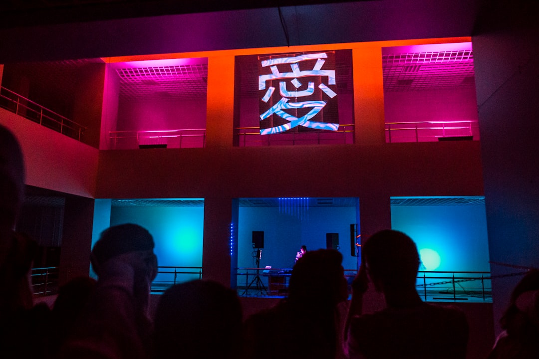 silhouette of people standing in front of the stage