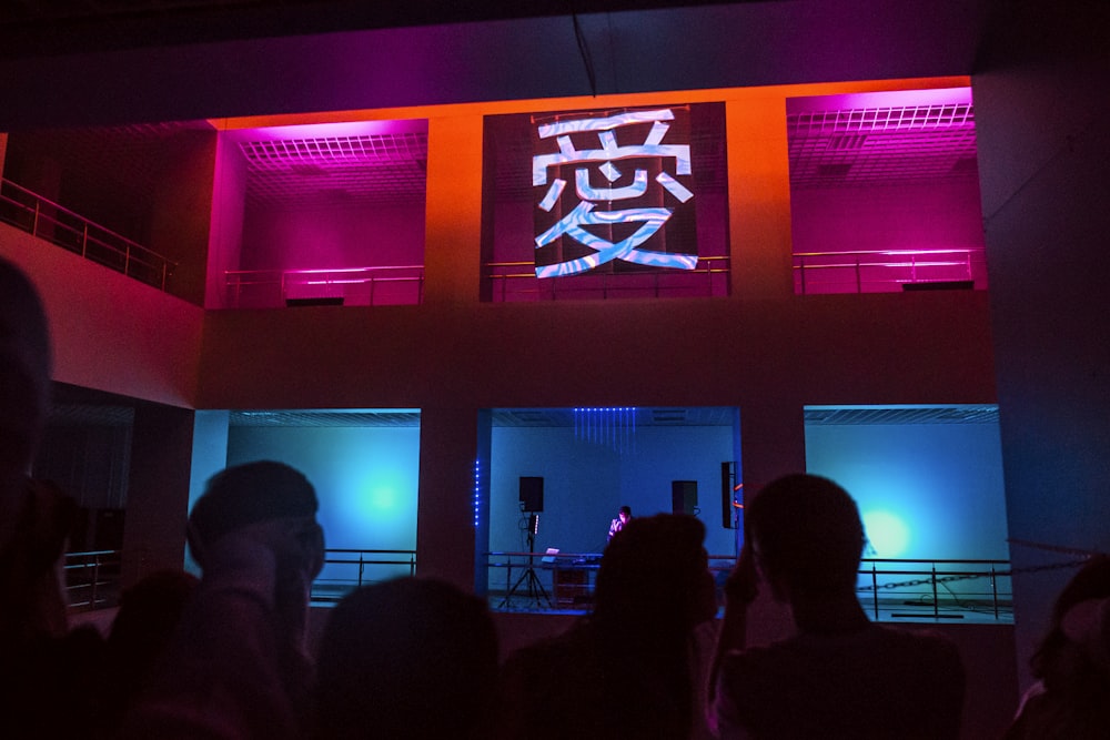 silhouette of people standing in front of the stage