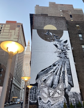 Finished mural on an urban building facade with elegant, minimalistic design.