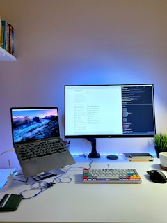 black flat screen computer monitor turned on beside black computer keyboard and black computer mouse