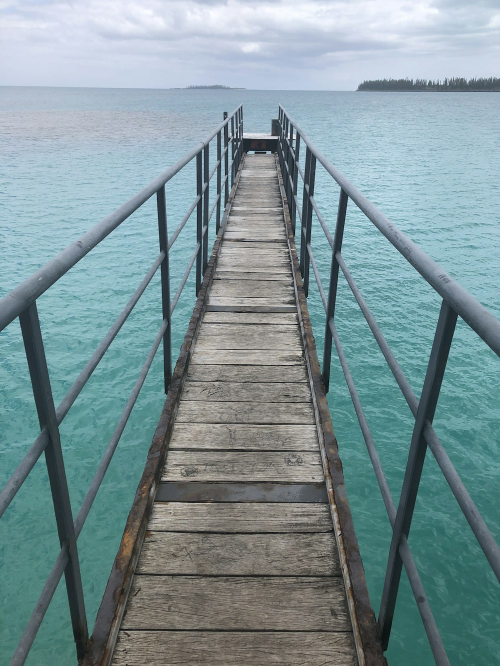 brown wooden dock on blue sea during daytime