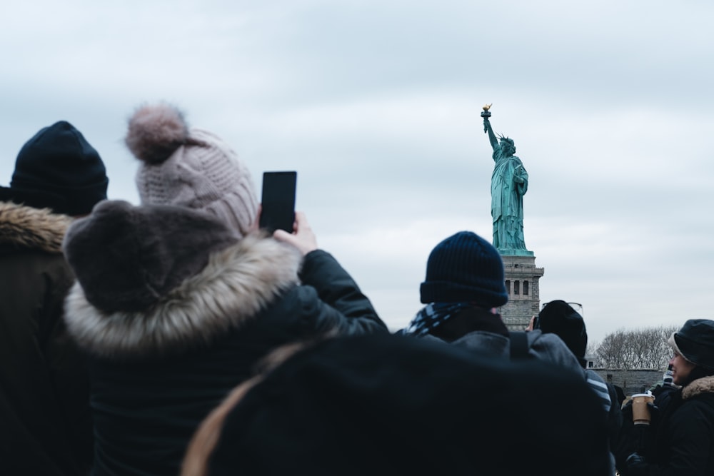 people standing near statue during daytime