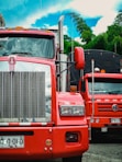 red and white truck on road during daytime