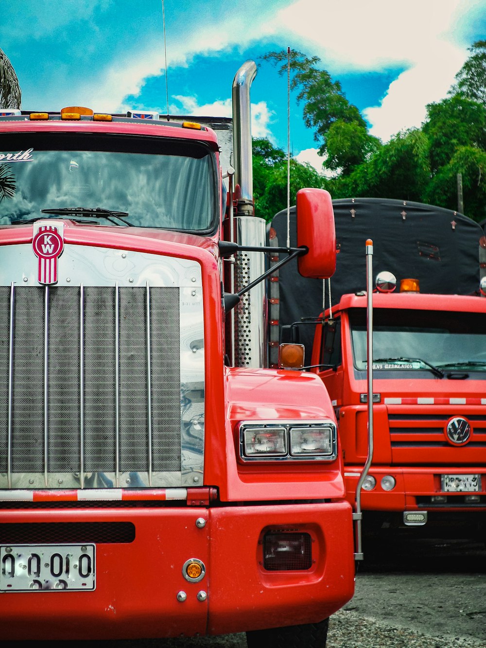 red and white truck on road during daytime