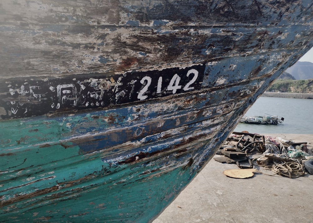 brown and blue boat on gray sand