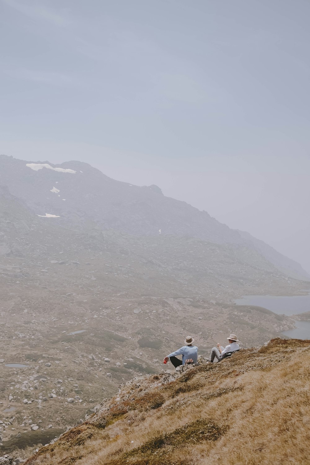 people sitting on brown rock formation during daytime