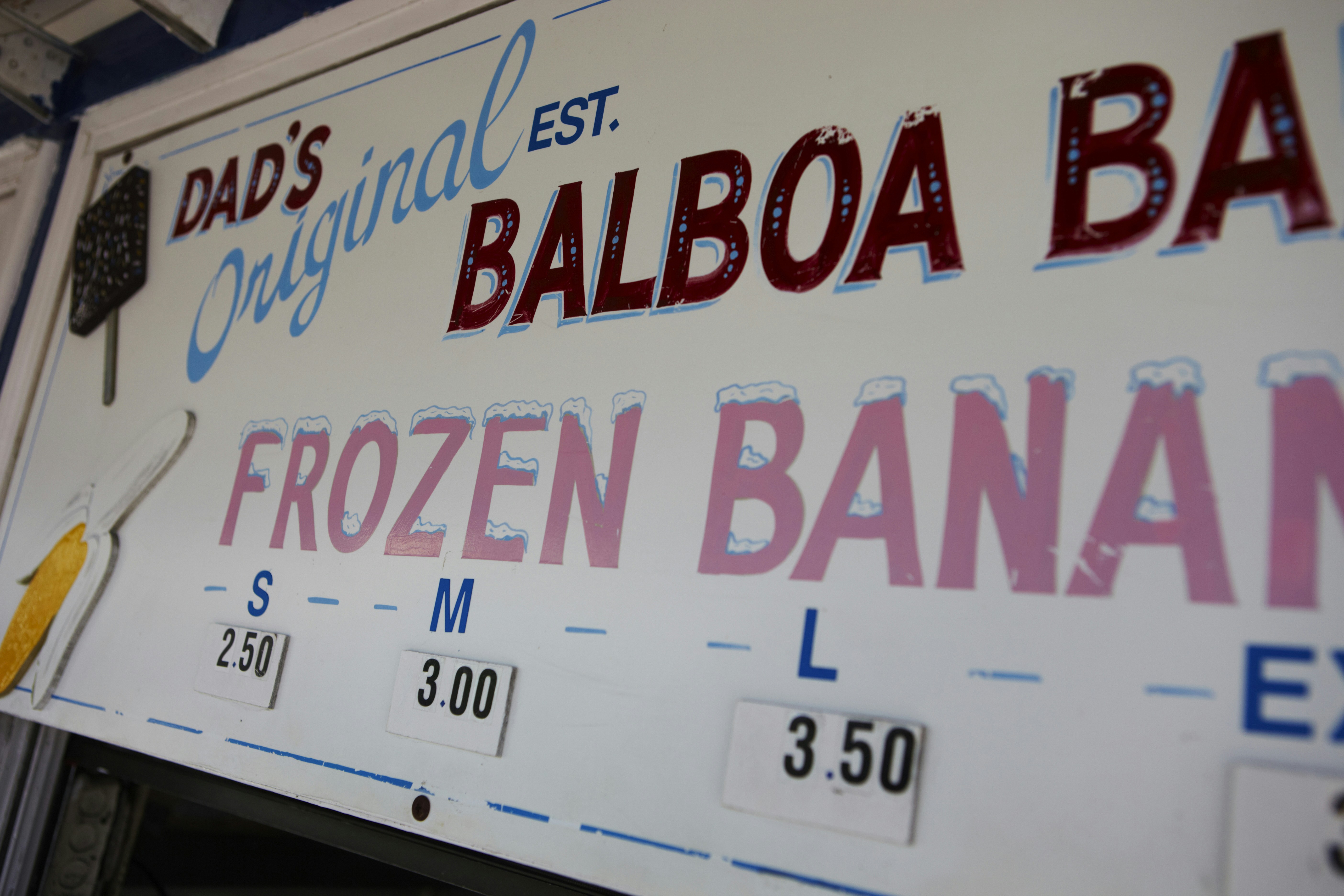 a sign for a frozen banana store