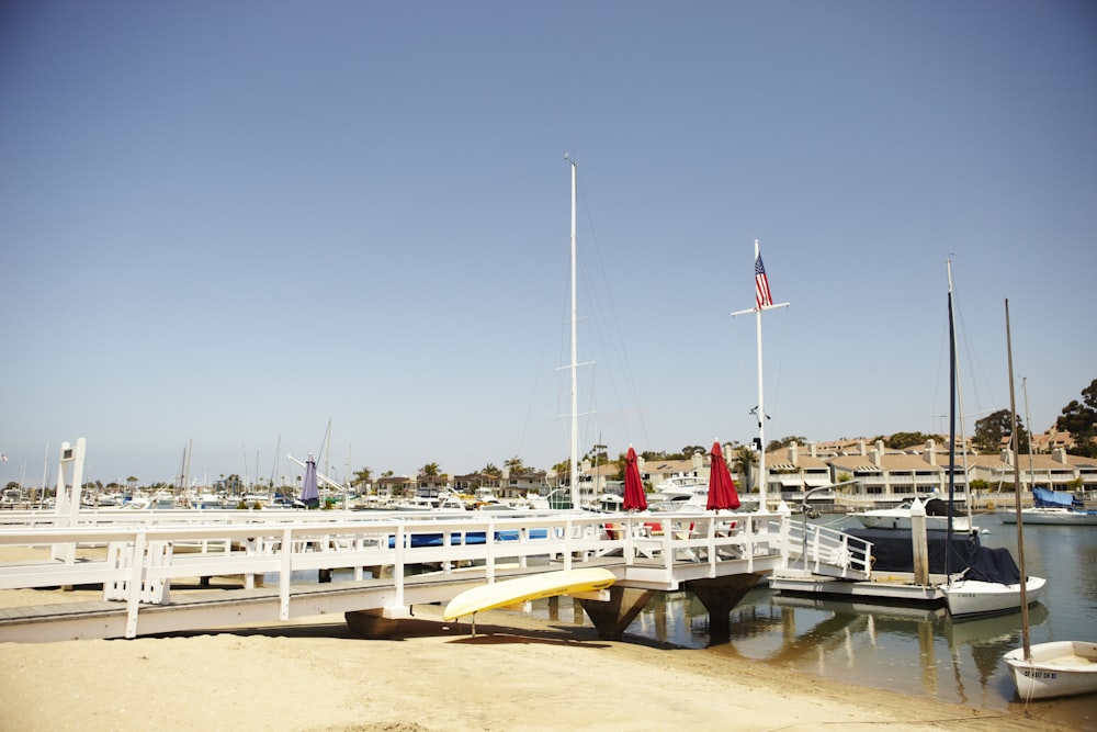 white and yellow boat on sea dock during daytime