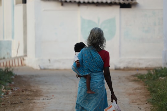 girl in blue dress walking on street during daytime in Tamilnádu India