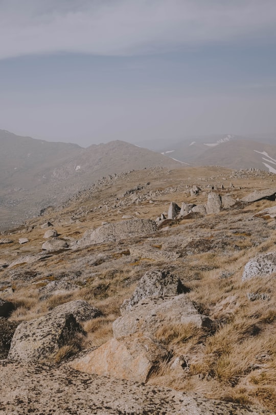 gray rock formation on green grass field during daytime in Kosciuszko National Park NSW Australia