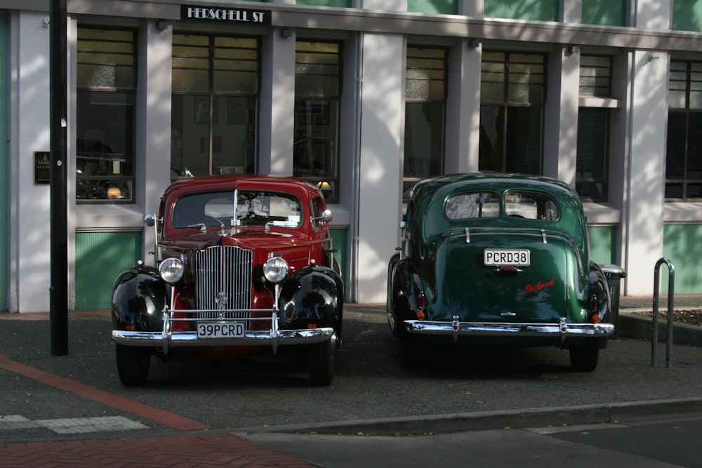 vintage green and red car parked on the street
