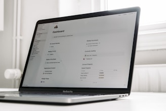 a laptop computer sitting on top of a white table