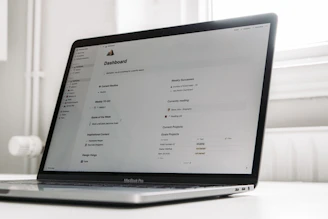 a laptop computer sitting on top of a white table