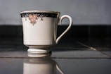 Close-up of a handcrafted ceramic mug with a delicate floral pattern