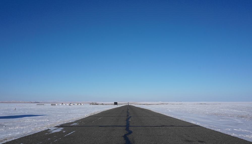 gray concrete pathway near sea during daytime