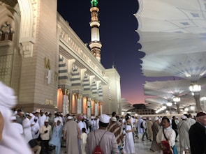 An outdoor gathering around a mosque during a festive occasion.