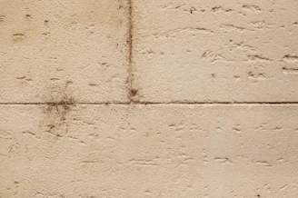 Before and after images showing soot removal from a residential wall.
