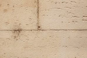 Before and after view of a building wall showing restored clarity and cleanliness.