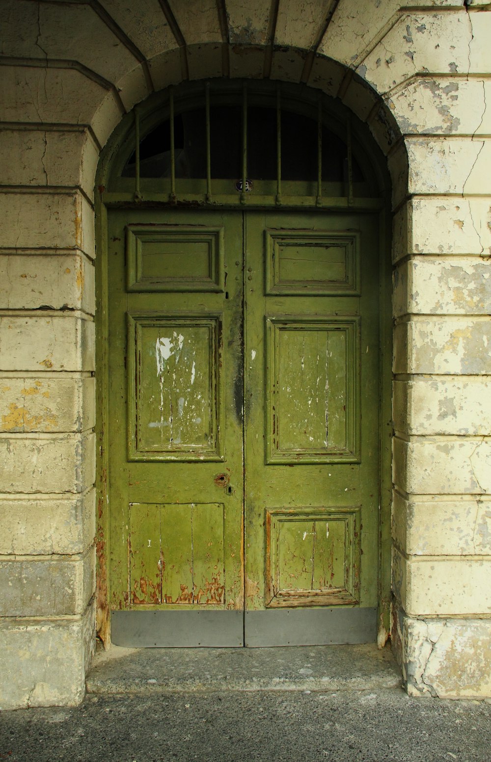 blue wooden door on gray brick wall