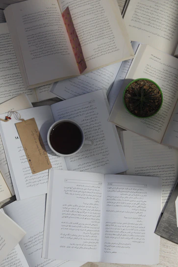 A cozy study corner with Islamic books and a cup of tea, reflecting a peaceful madrasah environment.
