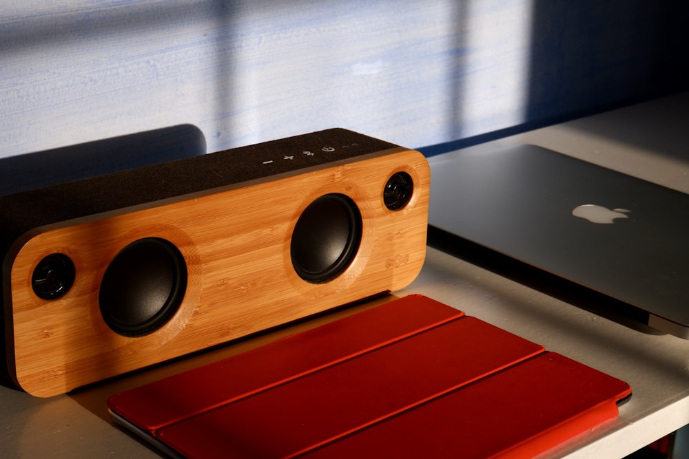 brown and black speaker on red textile