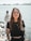 woman in black crew neck t-shirt wearing brown framed eyeglasses standing on rocky shore during