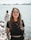 woman in black crew neck t-shirt wearing brown framed eyeglasses standing on rocky shore during