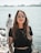 woman in black crew neck t-shirt wearing brown framed eyeglasses standing on rocky shore during