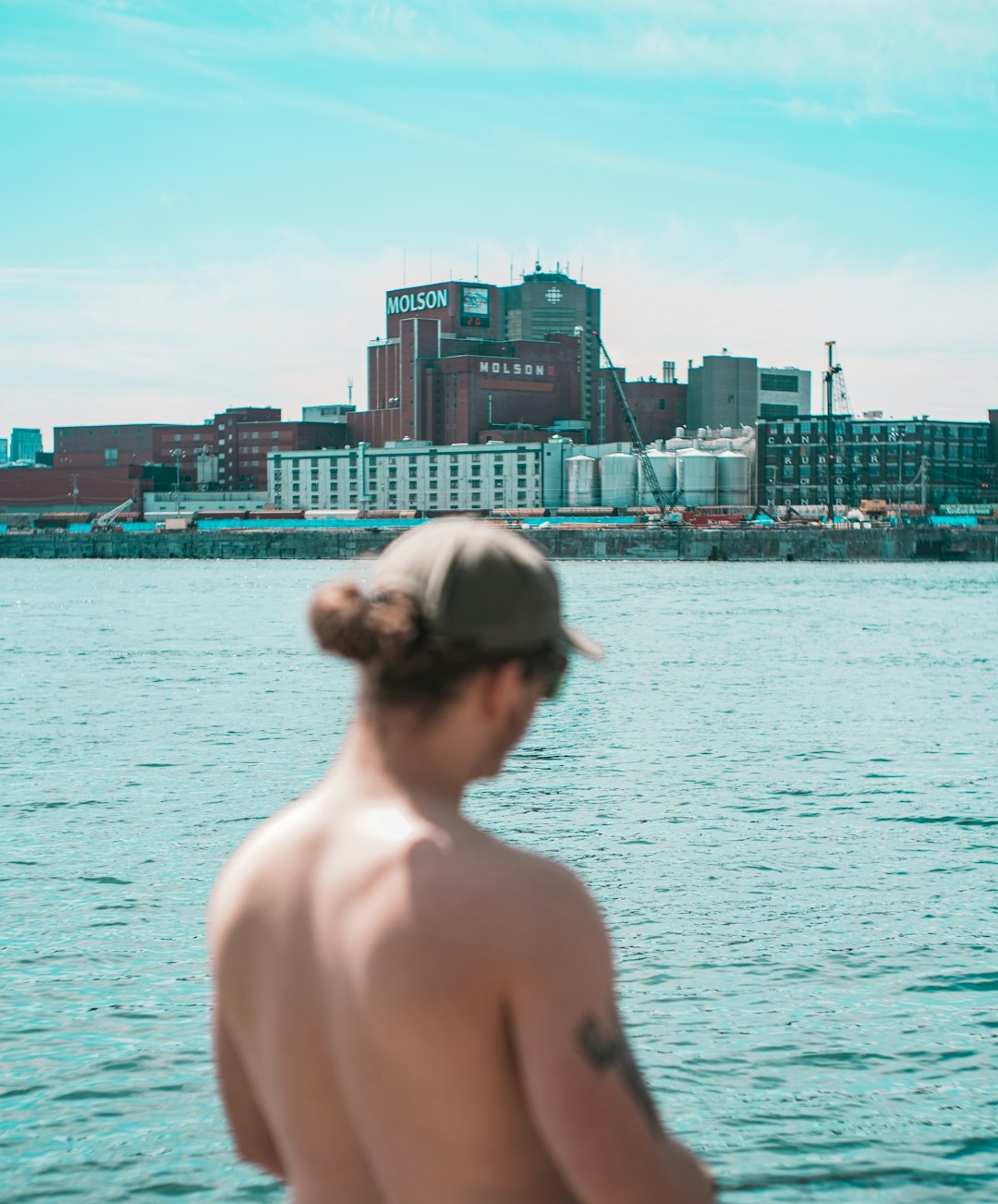 topless woman standing near body of water during daytime