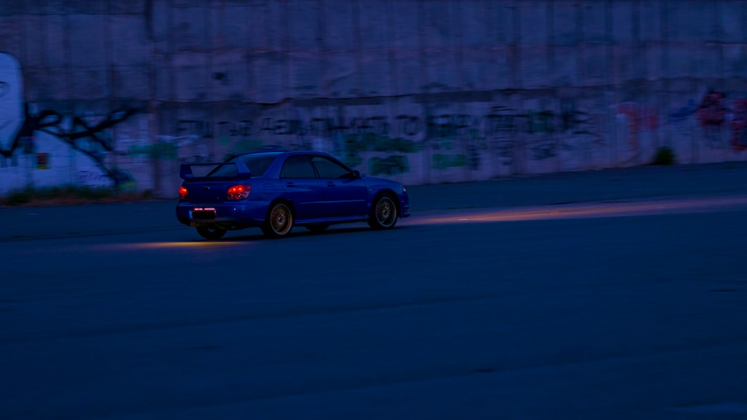 blue sedan on road during daytime