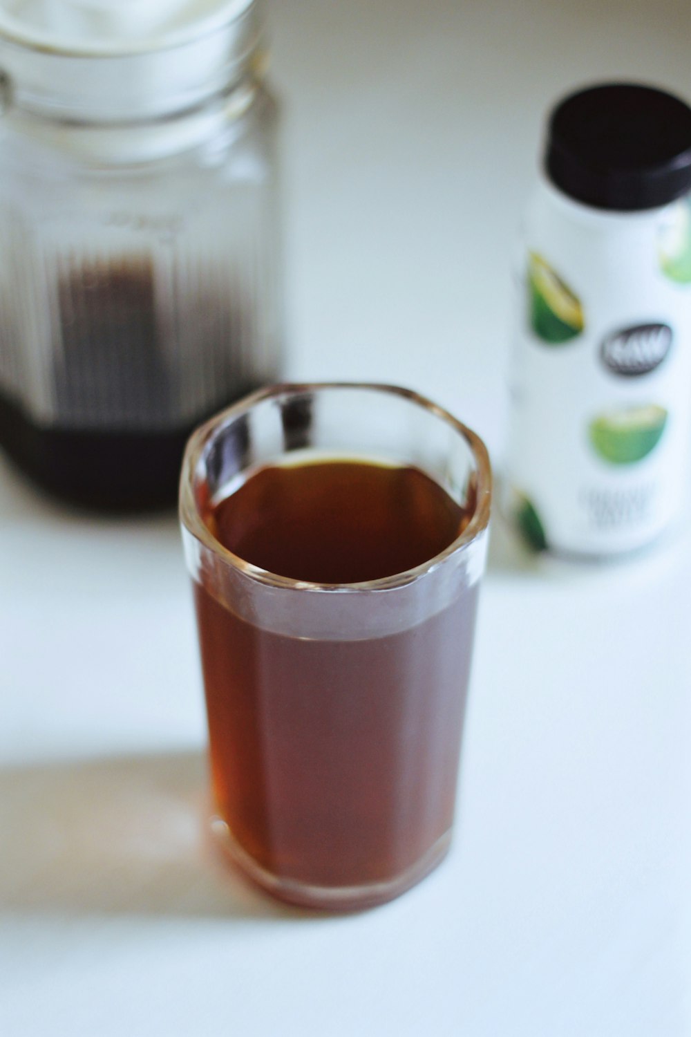 clear drinking glass with brown liquid