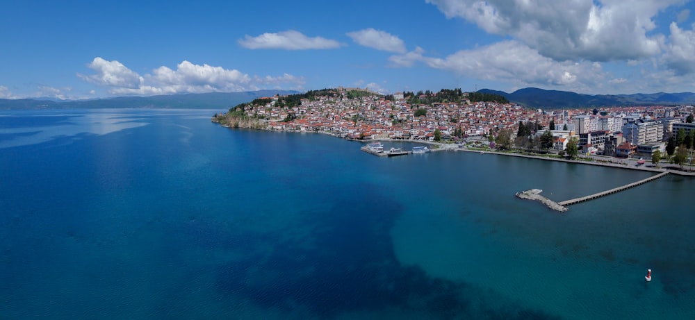 city buildings near body of water under blue sky during daytime