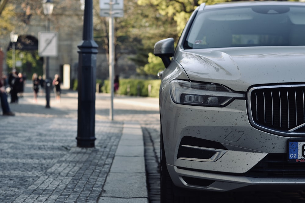 silver car parked on sidewalk during daytime