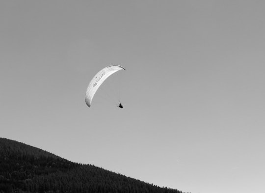 person riding parachute in grayscale photography in Laveyron France