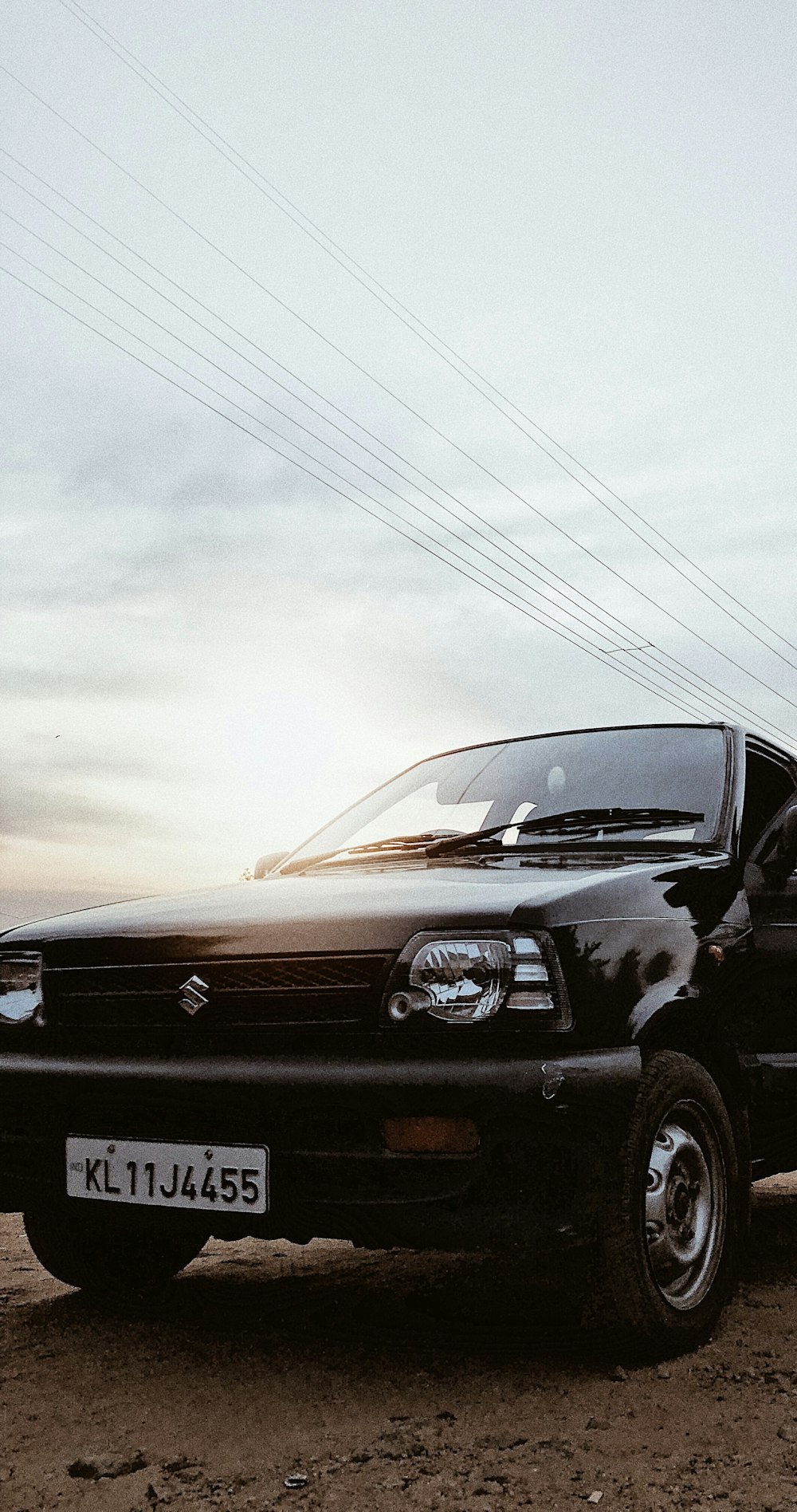 black suv on road under white sky during daytime