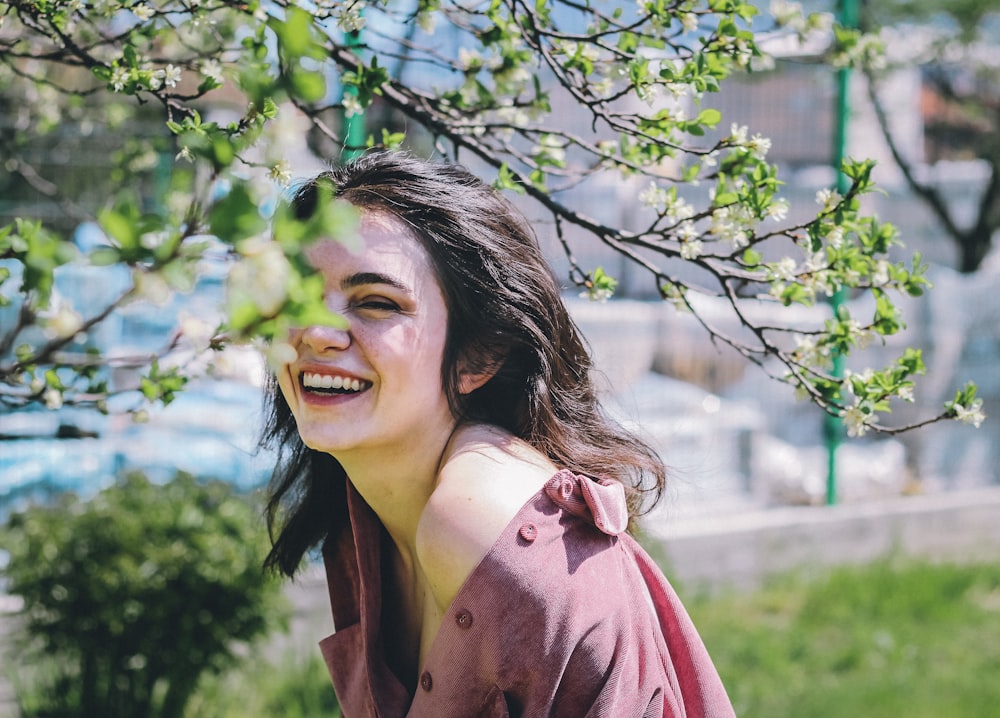 woman in pink coat smiling