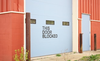 white and brown wooden wall with white and black wooden signage