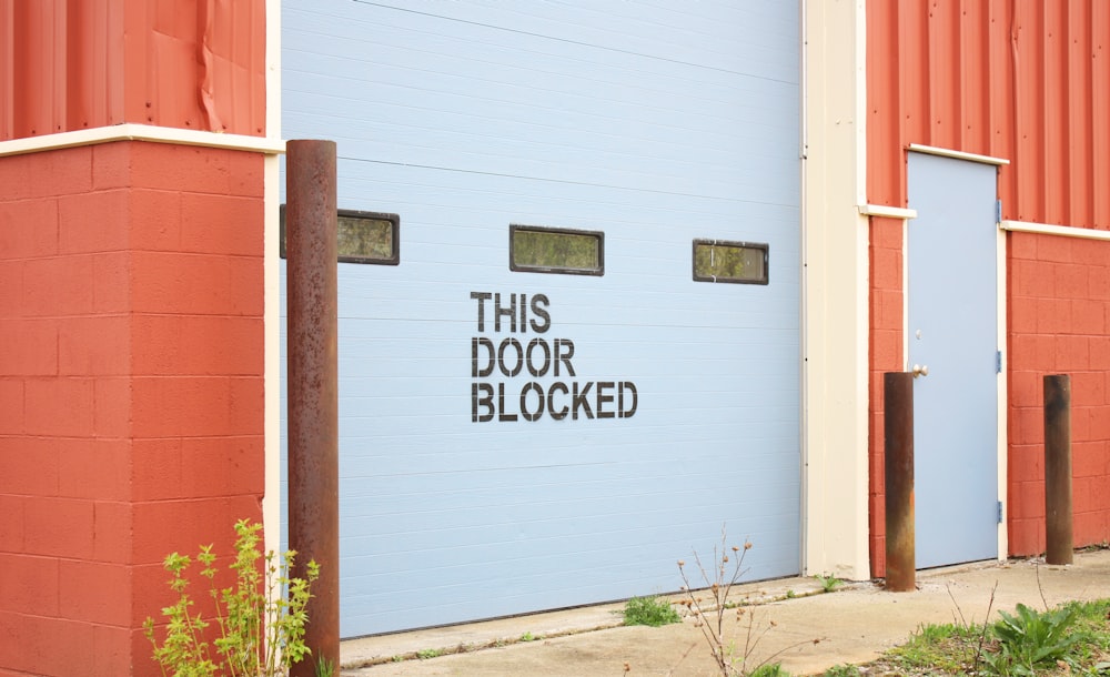 white and brown wooden wall with white and black wooden signage