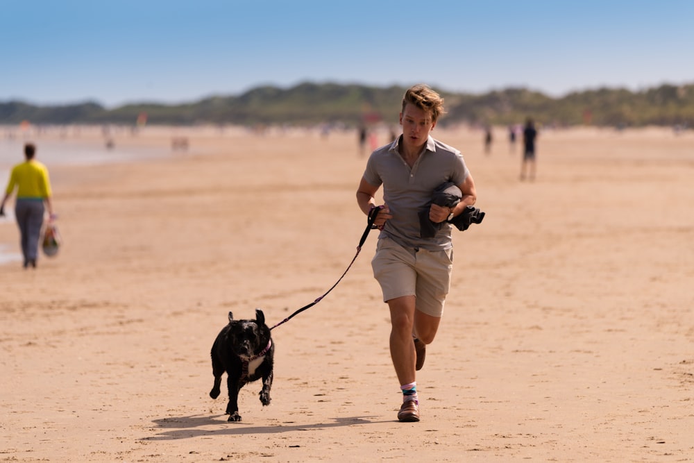 woman in gray long sleeve shirt and white shorts holding black short coated dog during daytime