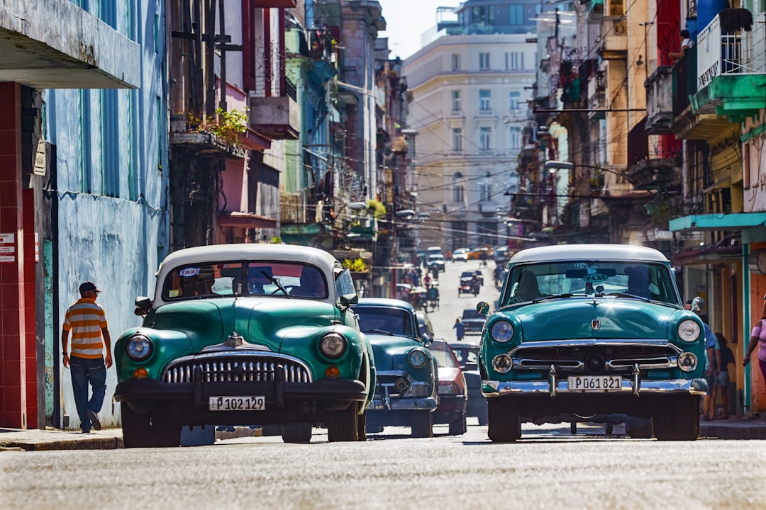 green car parked on the side of the road