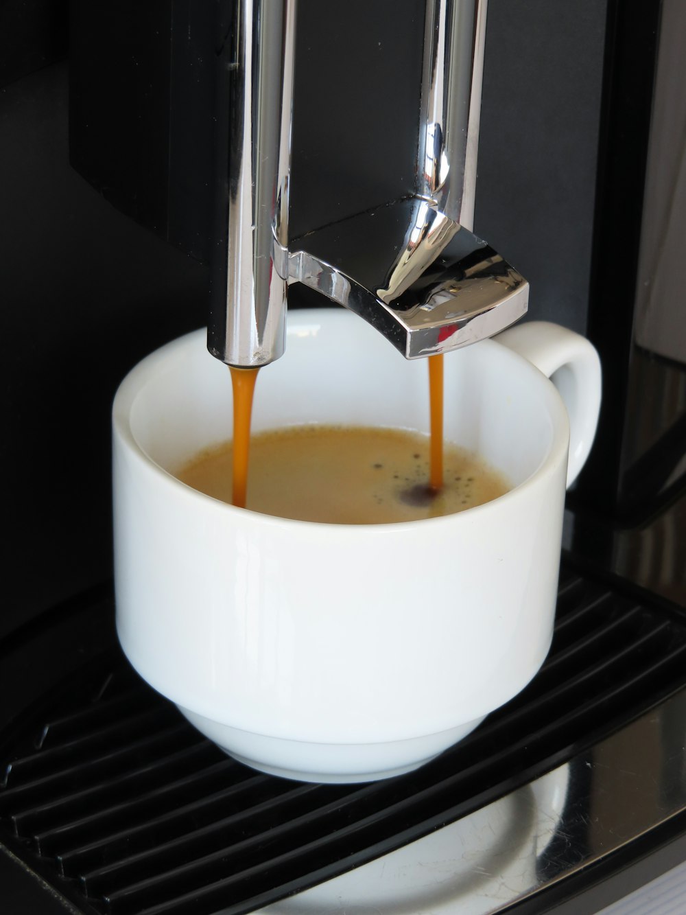 white ceramic cup with brown liquid